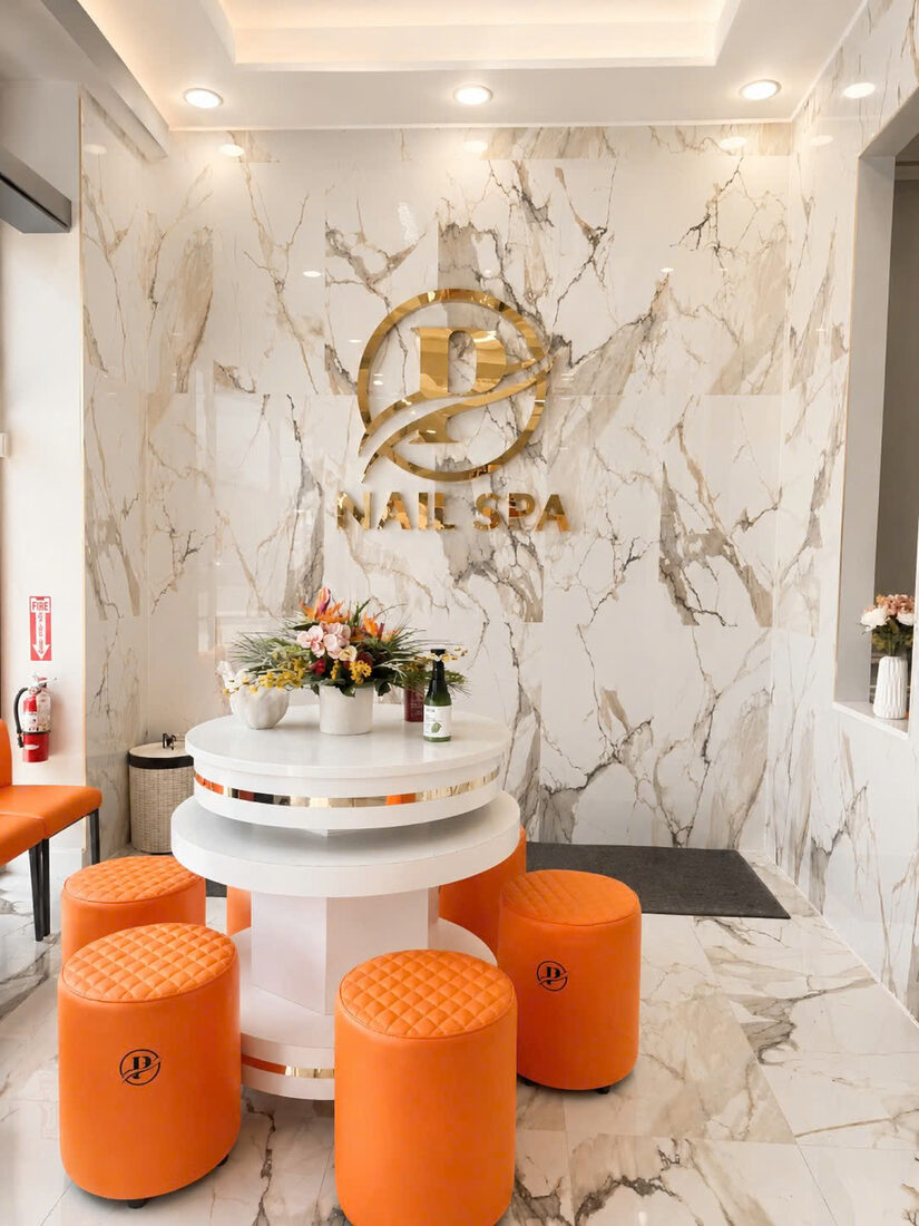 Perfection Nail Spa VI entrance with gold logo on marble wall