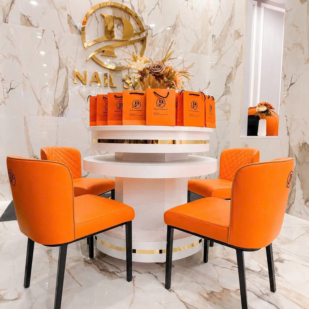 Perfection Nail Spa VI waiting area with gold logo and branded gift bags